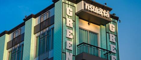A building with the name "GREEN" prominently displayed on its facade.