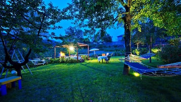 Relax in the serene garden, where a dining area and hammock await.
