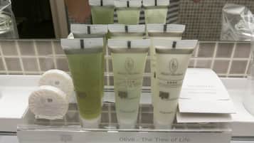 A display of Hotel Basilion products including shower cap, body milk, and conditioner.