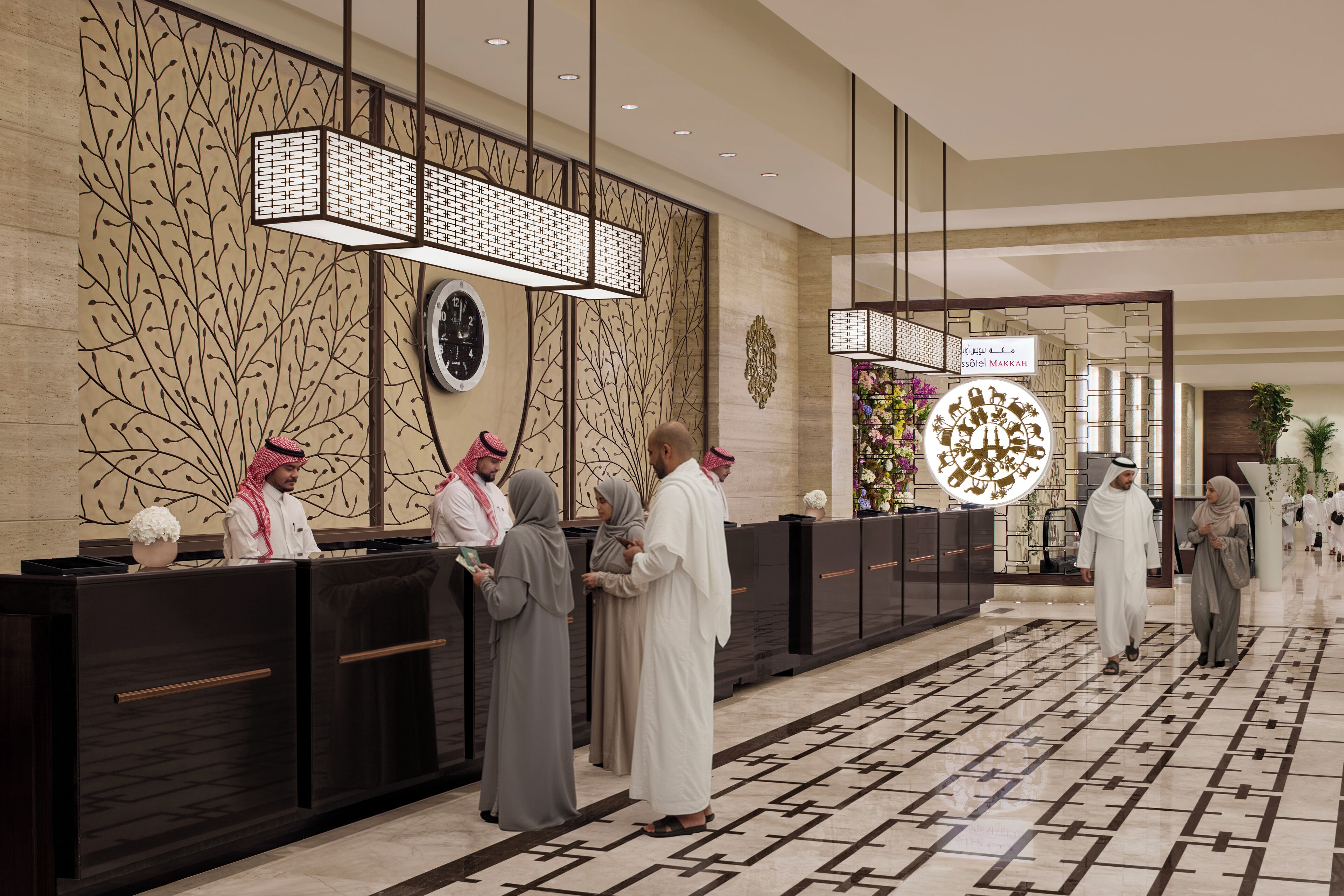 A hotel reception area with a modern design, including a reception desk, decorative wall panels, and a patterned floor.