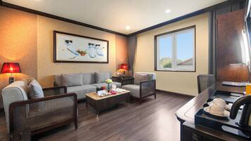 A modern living room with a sofa, chairs, a coffee table, and a dining area with a table and chairs.