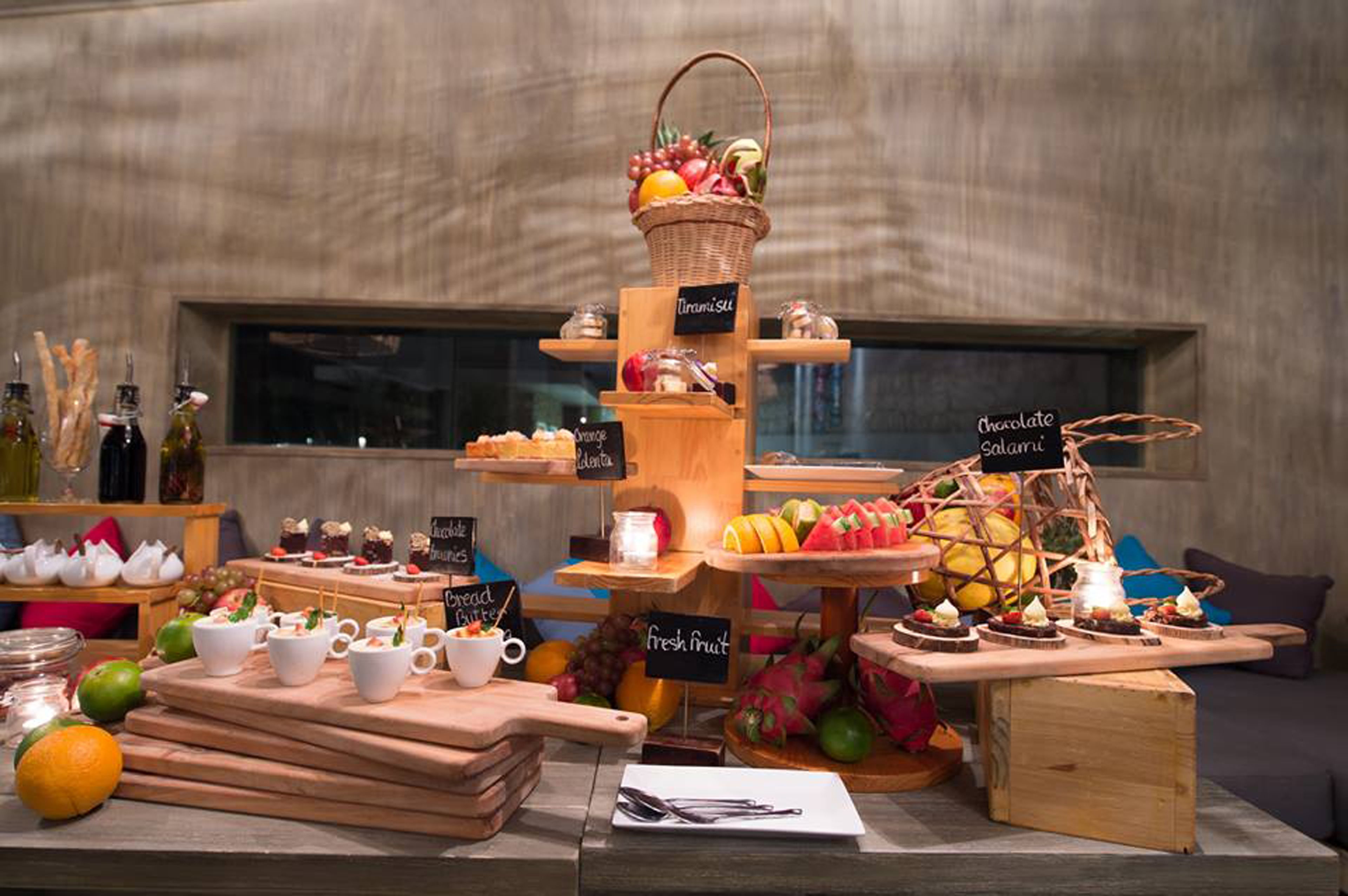 A food display with various items labeled, including bread, butter, orange, chocolate, and fresh fruit.