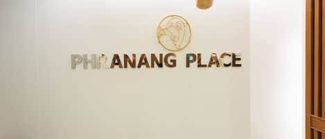 A clean, modern interior with a white wall and a logo above the text 'PHRANANG PLACE'.