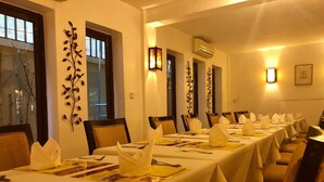 A conference room with long tables set for a meeting, equipped with nameplates, notepads, and pens. - Anise Hotel & Restaurant (Phnom Penh)