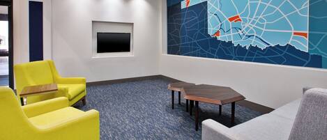 A conference room with a blue carpet, a large wall map, and two chairs.