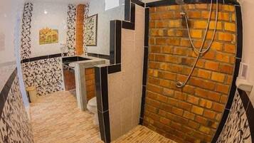 A bathroom with a shower, a toilet, and a sink.