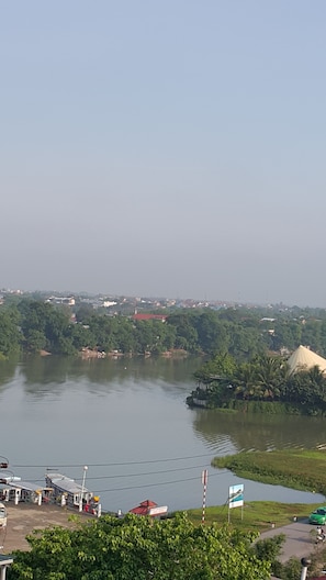 A river with a bridge, a small boat dock, and a signboard. - Than Thien Friendly Hotel (Hue)