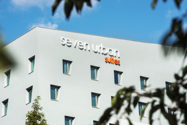 A building with a sign reading "seven urban suites."