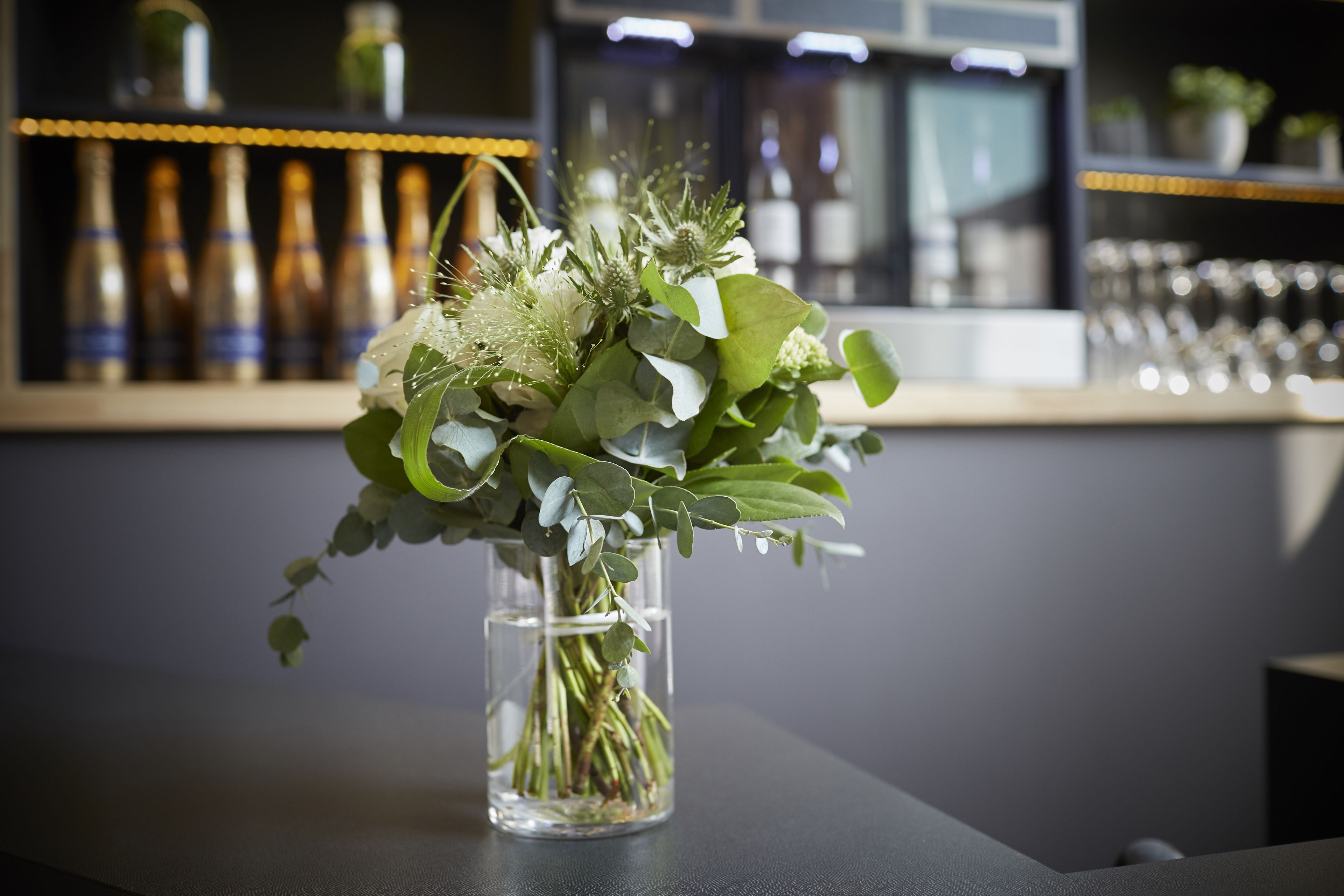 A clear glass vase with a floral arrangement on a table.