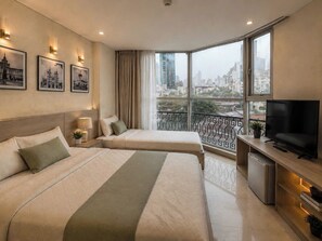 A hotel room with two beds, a TV, a mini-fridge, and a balcony with a city view. - Hikari Stay - Bui Vien CBD (Ho Chi Minh City)