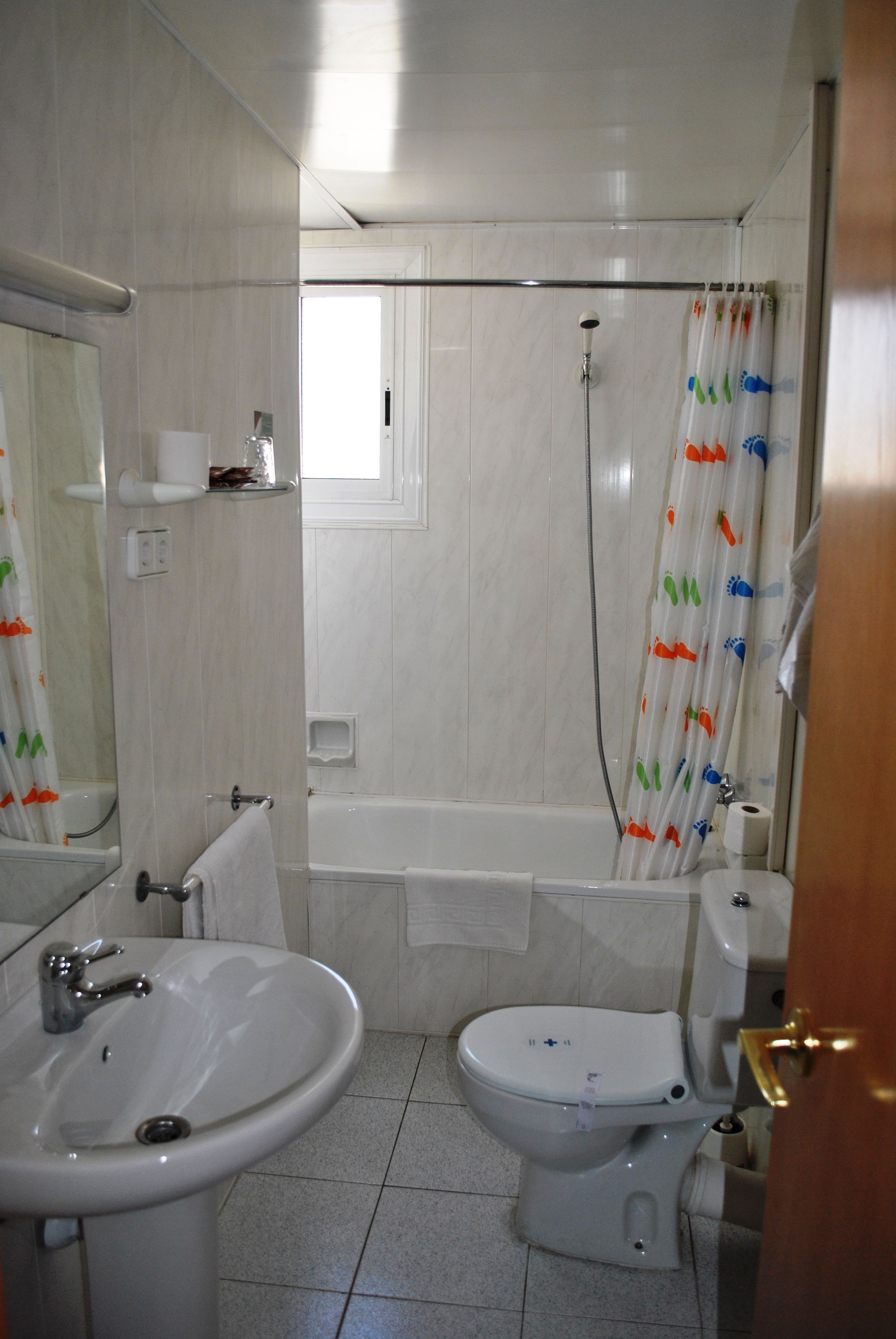 A bathroom with a sink, toilet, and bathtub.