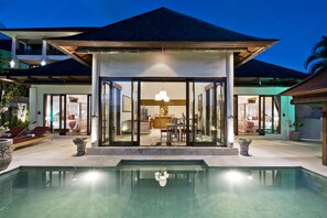 A modern resort with a pool, a covered dining area, and a two-story building with balconies. - Sahaja Sawah Resort (Selemadeg)