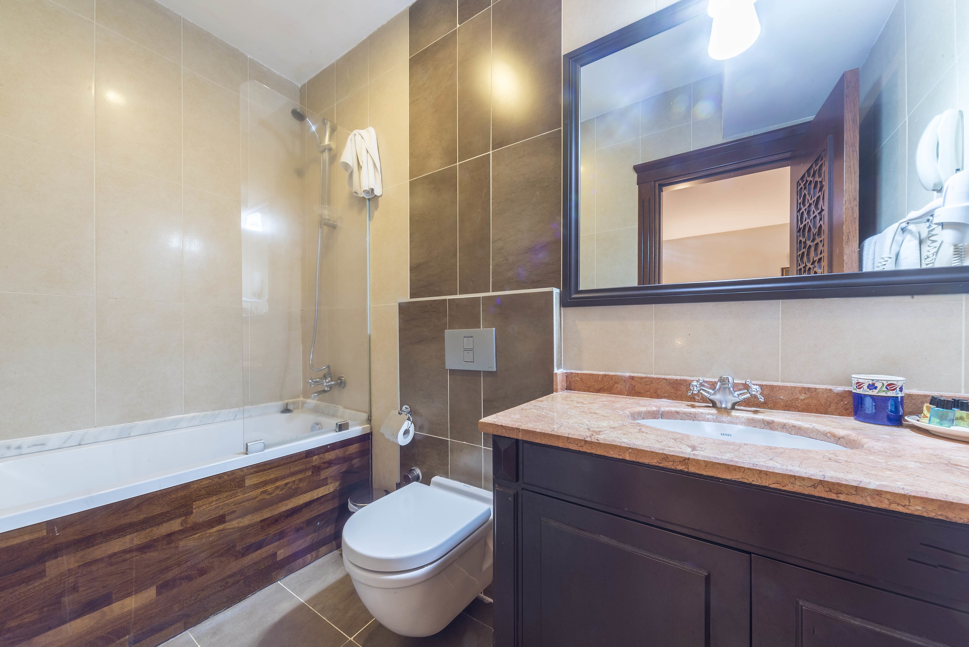 A modern bathroom with a bathtub, toilet, and sink.