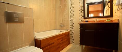 A modern bathroom with a toilet, bathtub, and sink.