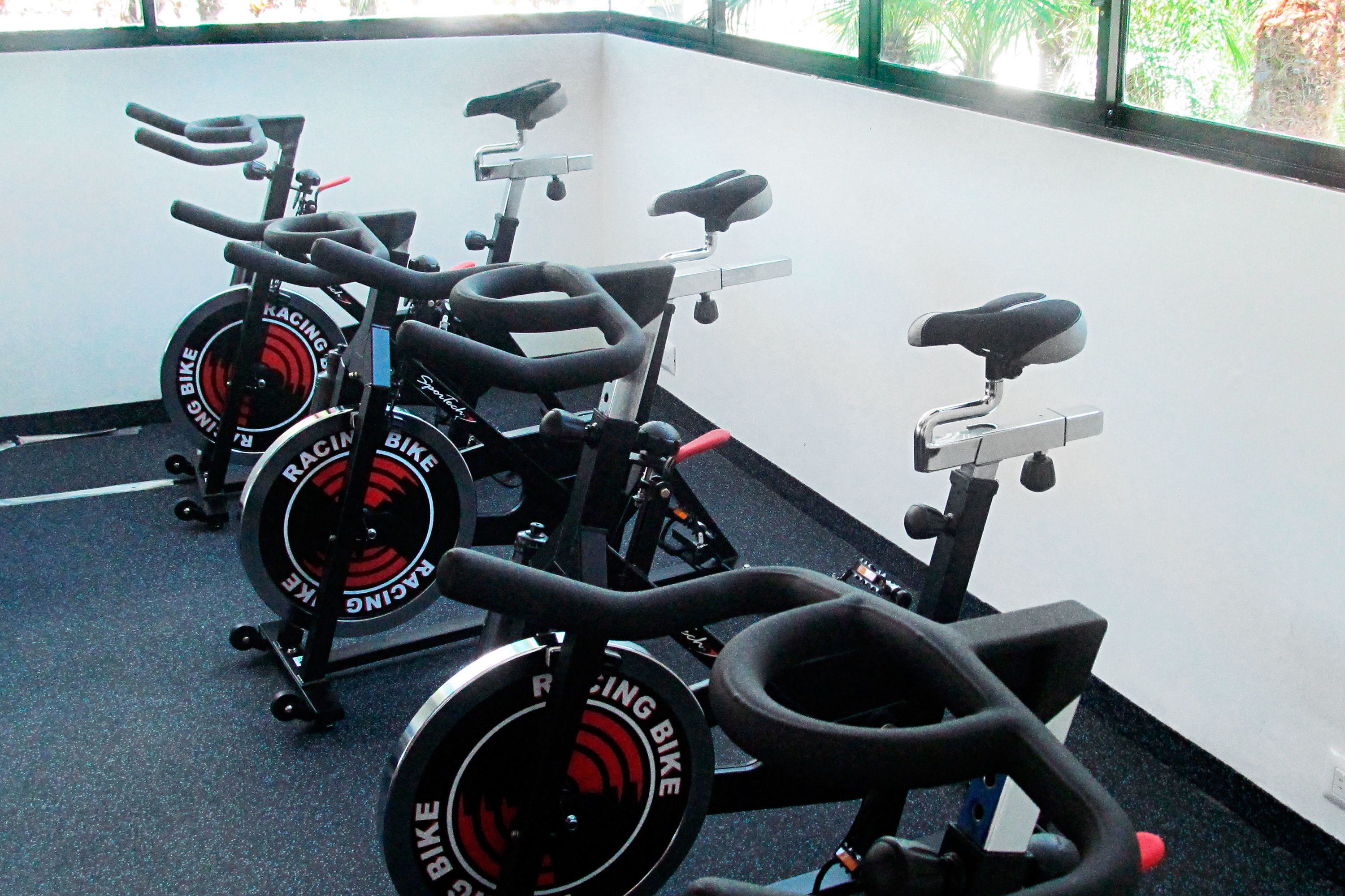 A gym with stationary bikes and exercise equipment.
