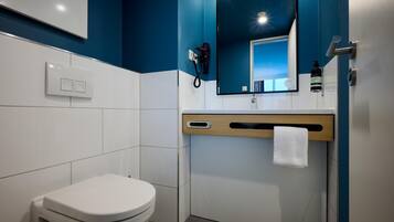 A modern bathroom with a white toilet, a mirror, and a towel rack.