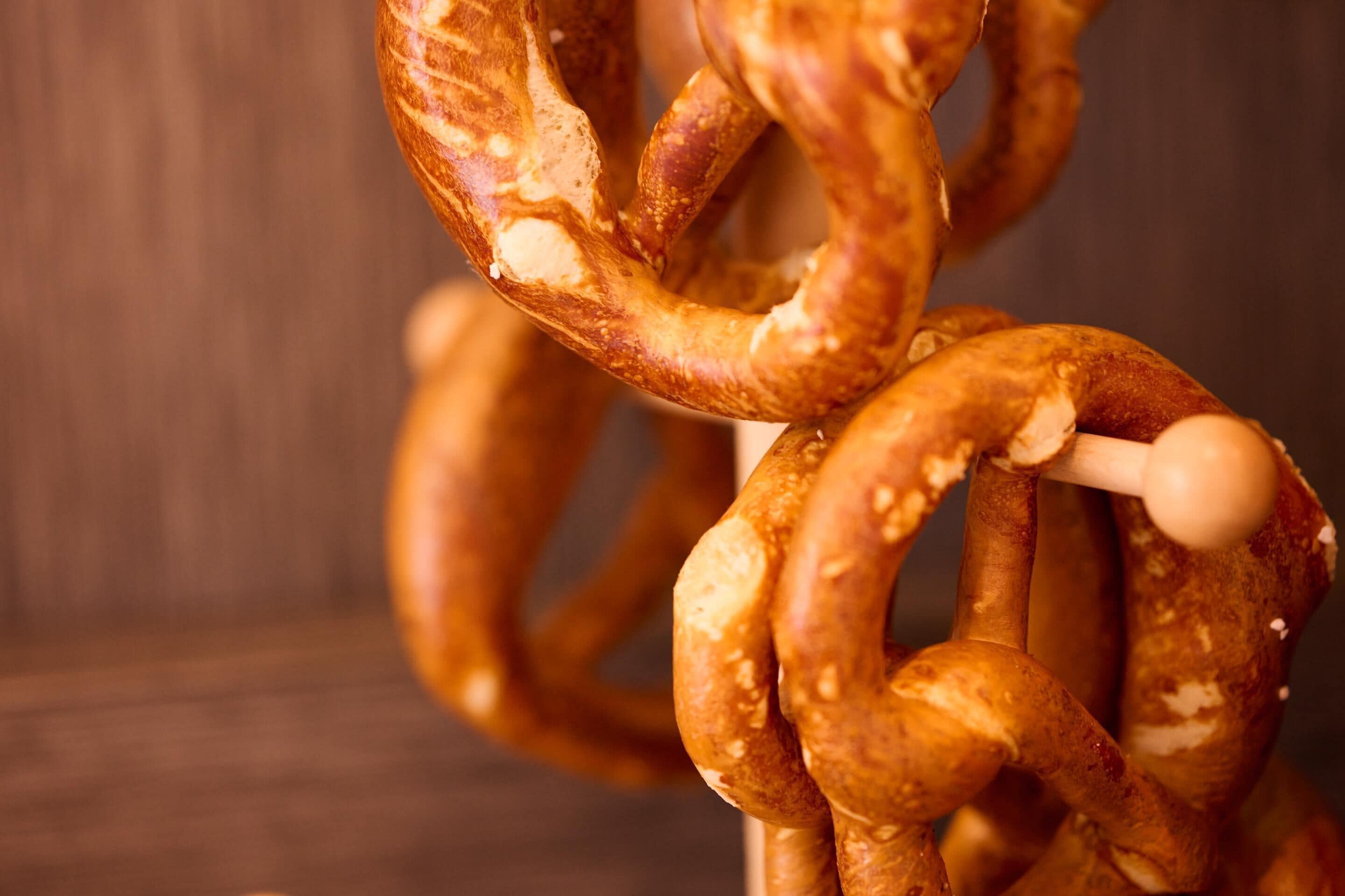 A close-up of a pretzel with a wooden background.