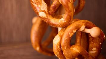 A close-up of a pretzel with a wooden background.
