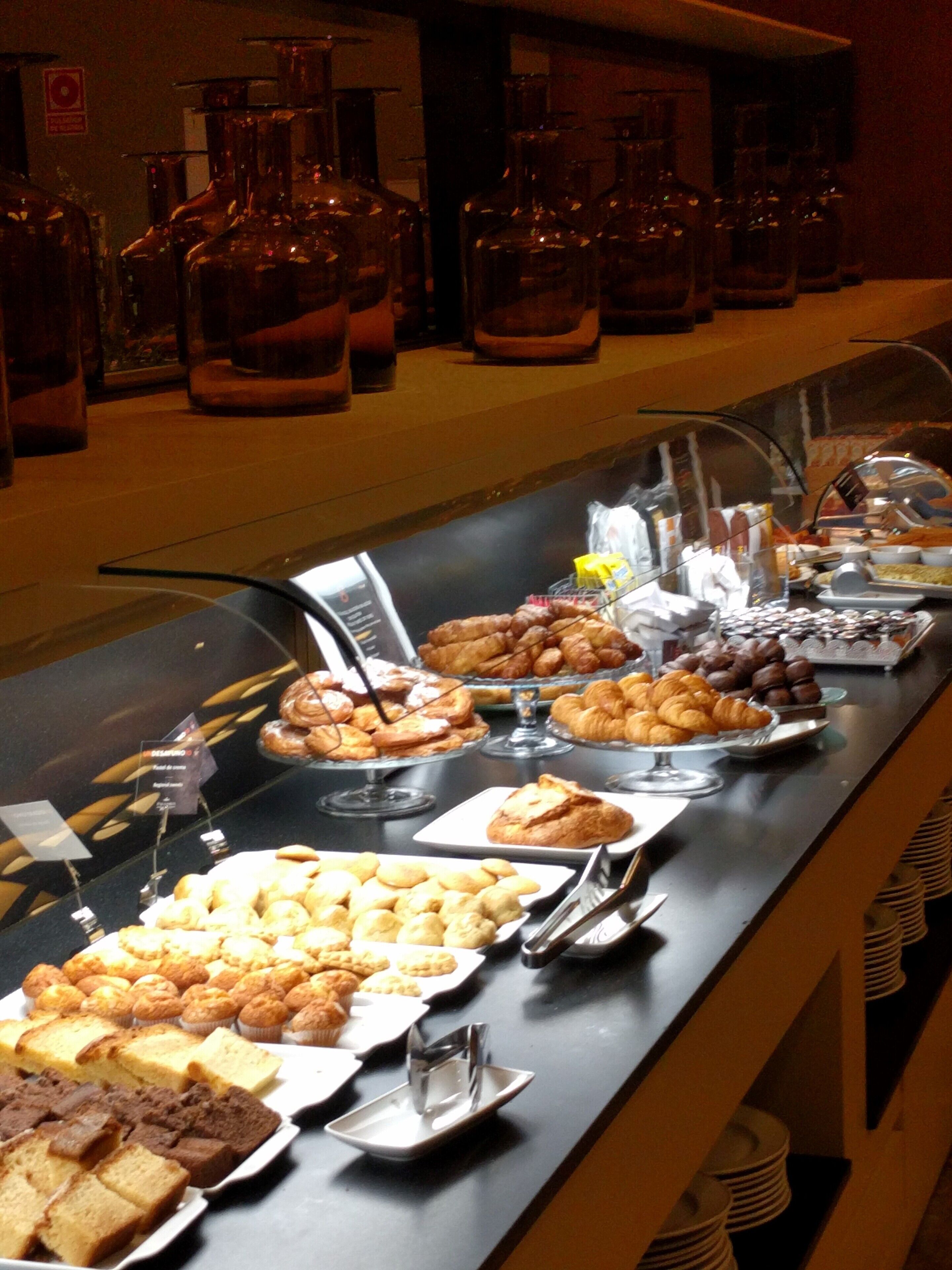 A buffet with various baked goods and pastries.