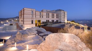 A modern building with a flat roof, large windows, and a staircase leading to the entrance. - Parador de Lorca (Lorca)