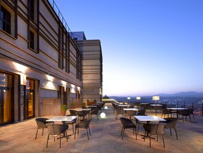 Relax and socialize in this outdoor dining area with comfortable seating and stunning views.