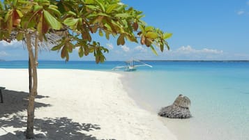 On the beach, white sand, sun loungers