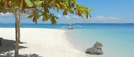 On the beach, white sand, sun-loungers