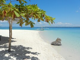 On the beach, white sand, sun loungers