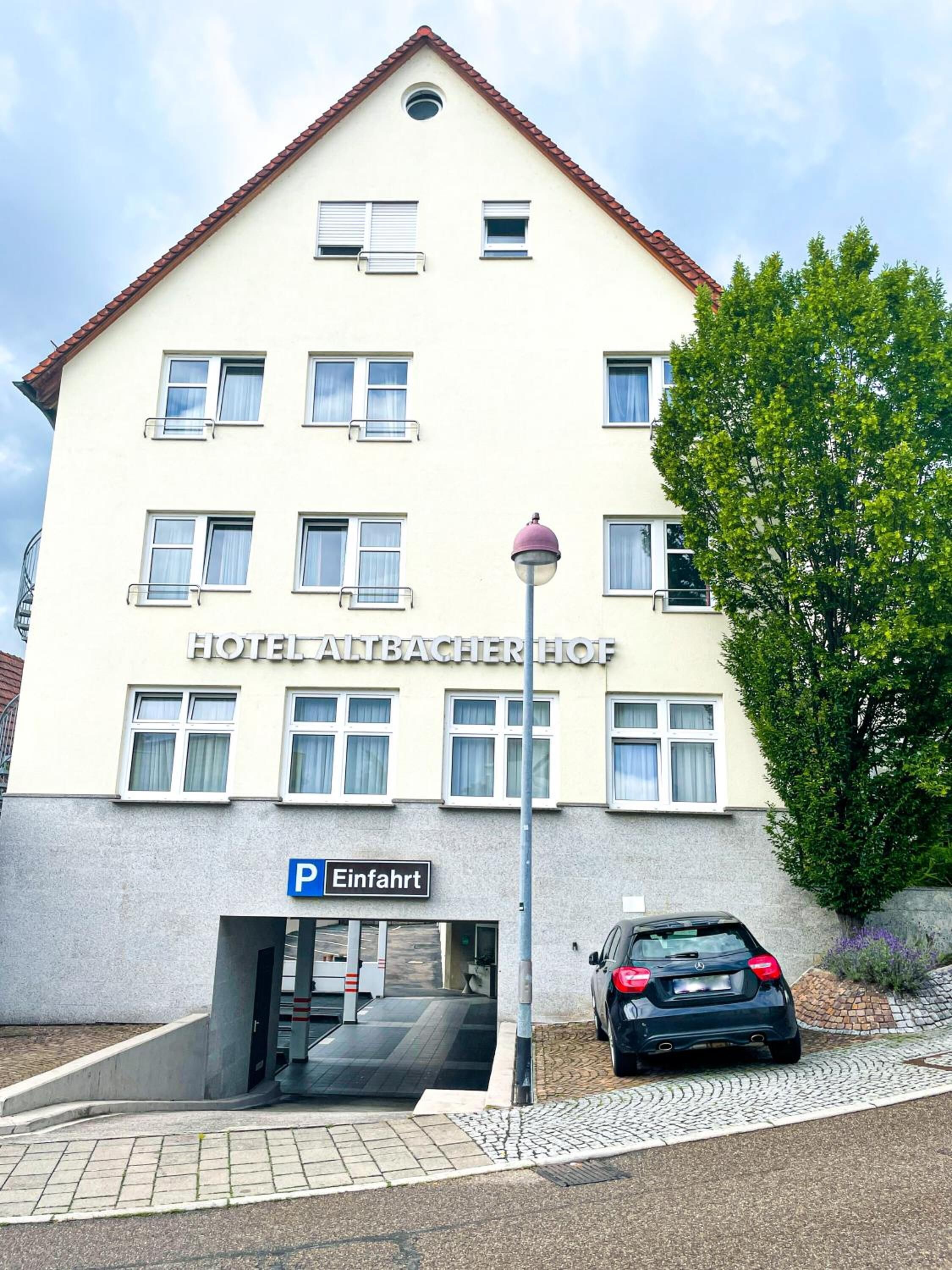A hotel building with a sign reading "HOTEL AUTBACHER HOF".