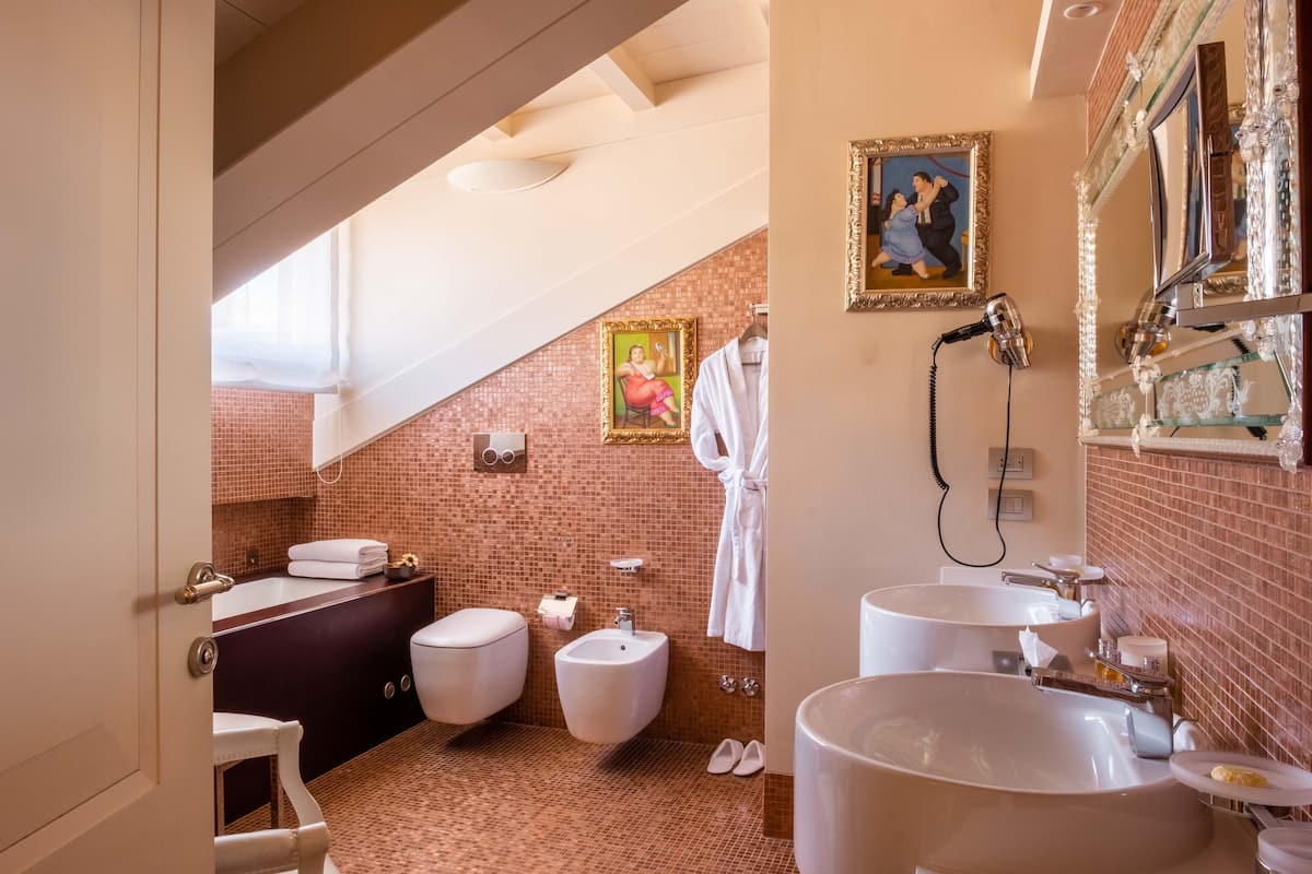 junior suite | bathroom | shower, eco-friendly toiletries, hair dryer, bathrobes