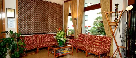 A traditional sitting area with two sofas, a coffee table, and a wooden floor.
