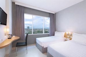 A hotel room with two beds, a desk with a chair, a TV, and a window with a city view. - favehotel Solo Baru (Grogol)