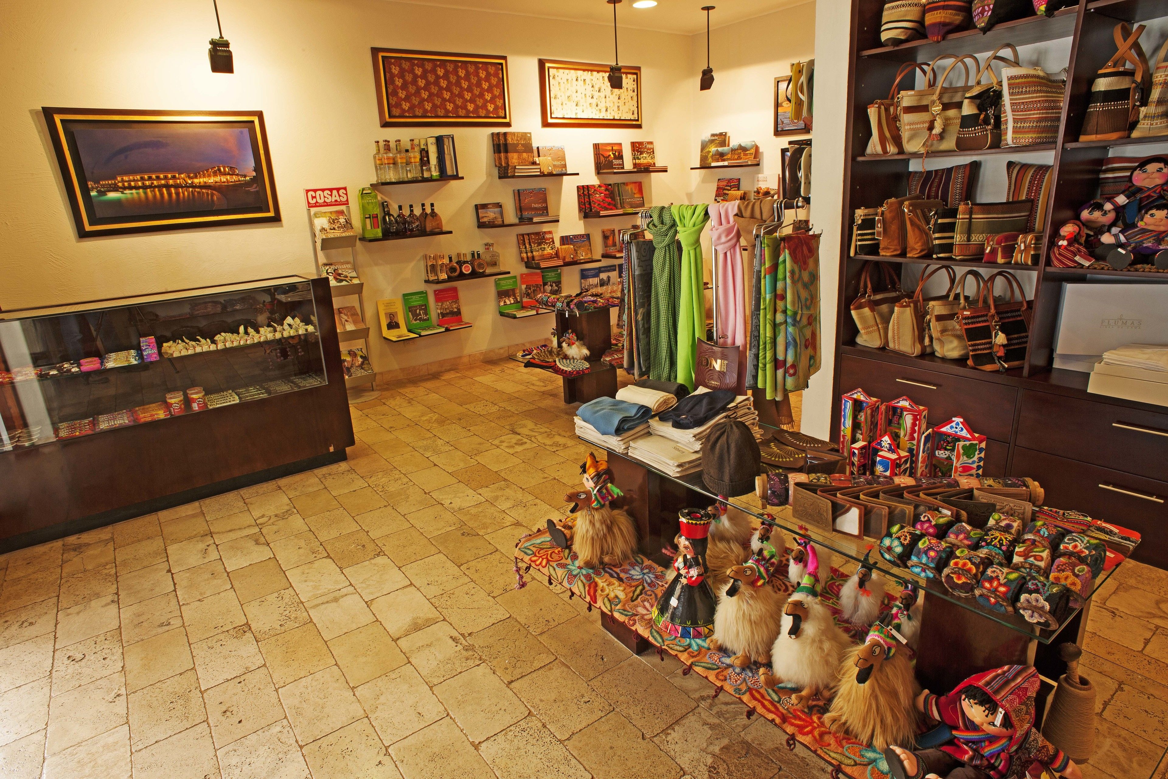 A boutique store with shelves of bags and a display of dolls.