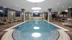 An indoor swimming pool with lounge chairs and a patterned floor. - Istanbul Gonen Hotel (Istanbul)