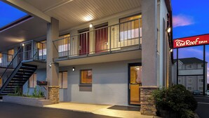 A two-story motel with a balcony, a staircase, and a Red Roof Inn sign. - Red Roof Inn Rock Hill (Rock Hill)