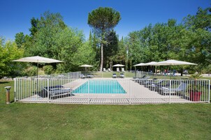 Seasonal outdoor pool, open 8:00 AM to 8:00 PM, pool umbrellas