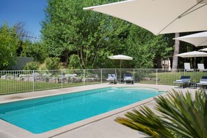 Seasonal outdoor pool, open 8:00 AM to 8:00 PM, pool umbrellas