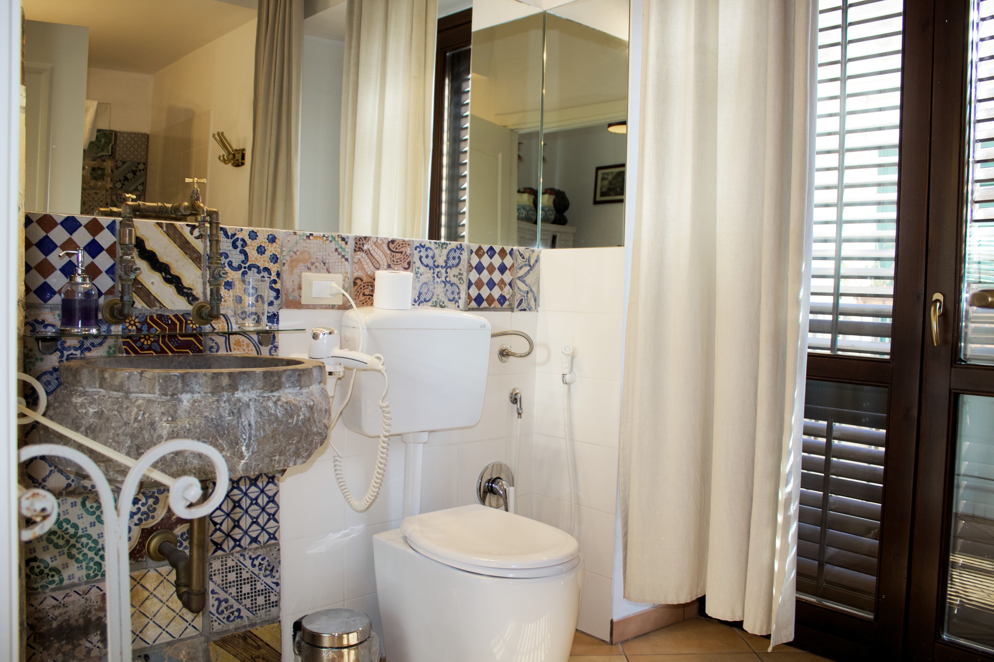 A bathroom with a toilet, sink, and shower.
