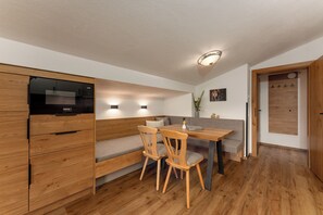 Exclusive Condo, 2 Bedrooms, Garden Area | Living room | 55-inch flat-screen TV with satellite channels, TV, toys - Bergbauernhof Irxner (Schladming)