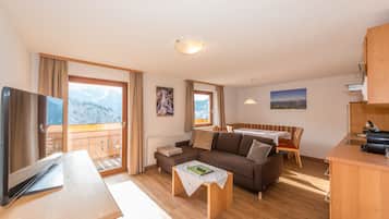 Comfort Condo, 2 Bedrooms, Balcony, Mountain View | Living room | 55-inch flat-screen TV with satellite channels, TV, toys