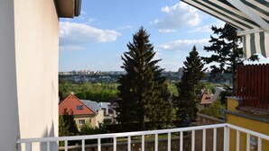 A balcony with a view of a cityscape, including buildings and trees. - Pension Nika (Prague)