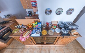 A kitchen counter with various food items and kitchen appliances.