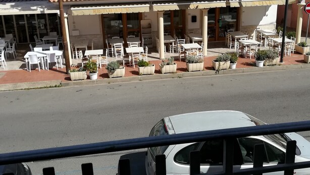 A restaurant with outdoor seating, a tiled roof, and a sign reading "Ristorante". - La Locanda del Mare (Siniscola)