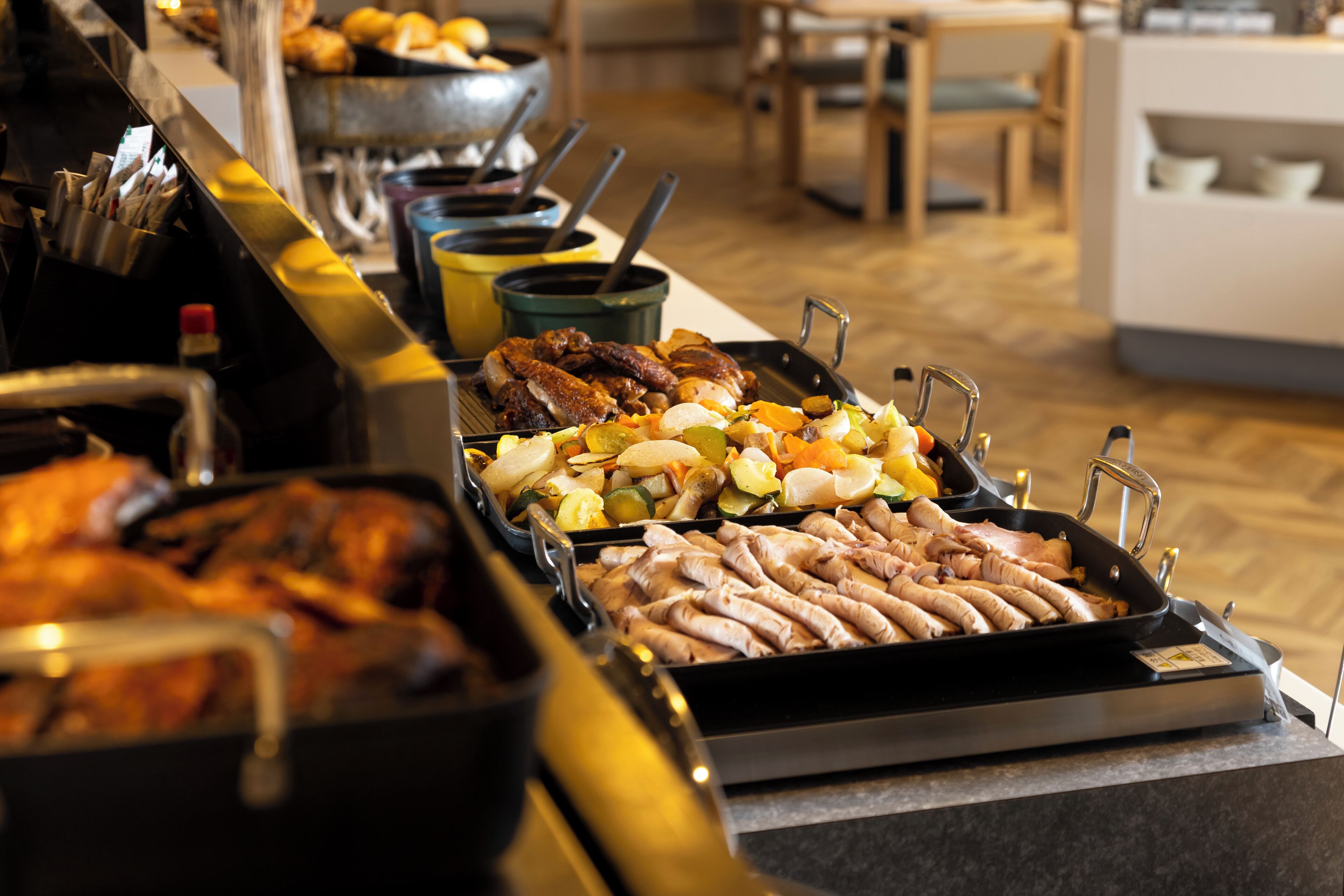 A buffet with various meats and vegetables.