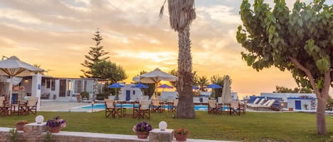 Seasonal outdoor pool, open 9 AM to 8:30 PM, pool umbrellas