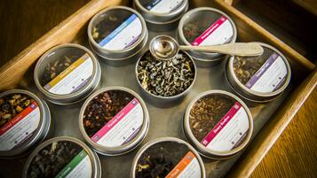 A tray with multiple small containers of tea, each labeled with different names and descriptions.