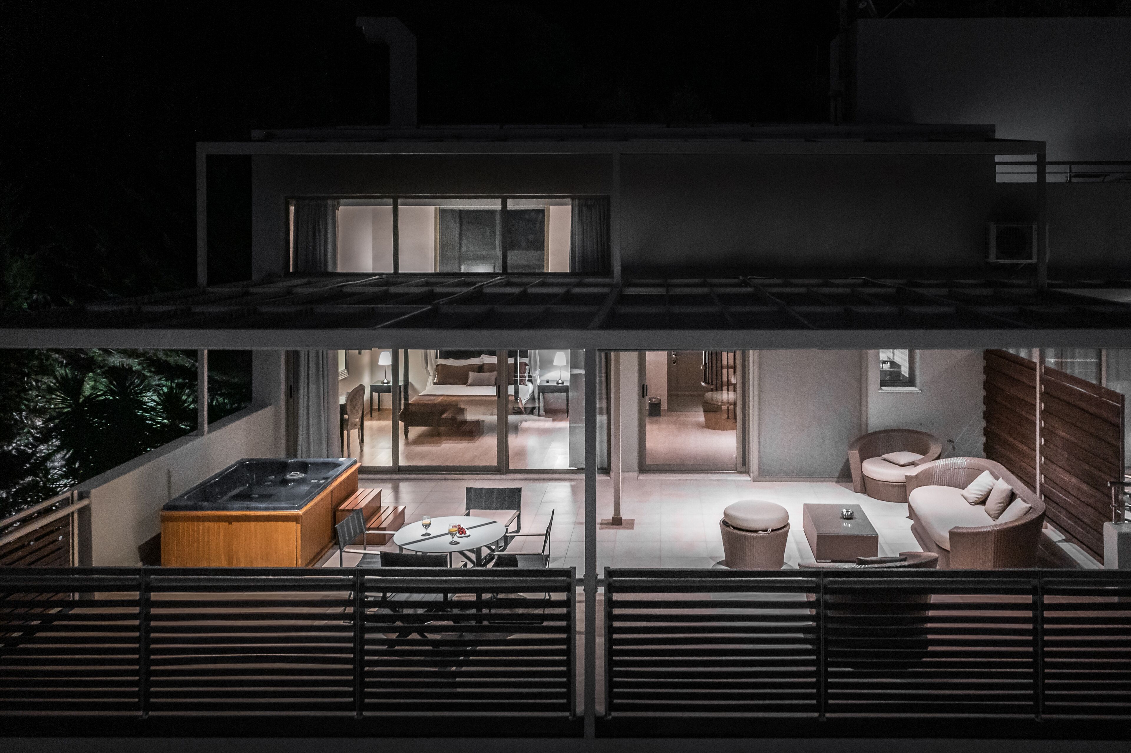 A modern two-story house with a dining area on the ground floor and a living room on the upper floor.
