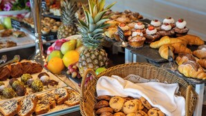 A buffet with various pastries, fruits, and desserts. - San Nicolas Resort Hotel (Lefkada)