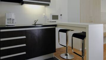 Fridge, microwave, coffee/tea maker, cookware/dishes/utensils