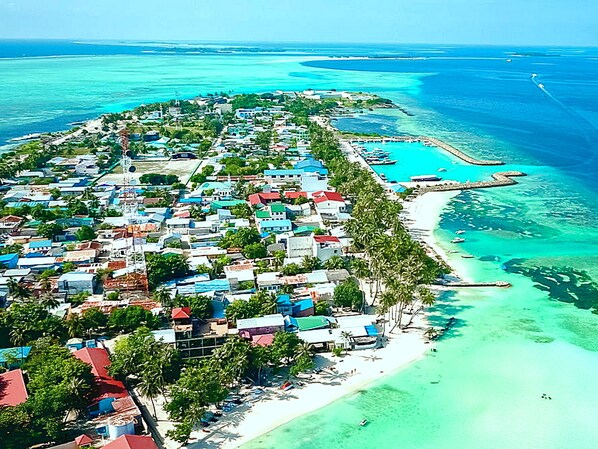 On the beach, white sand, sun loungers, beach umbrellas